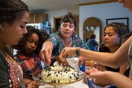 At her home in Tanana, Alaska, Cynthia Erickson and some young volunteers decorate a lemon-blueberry cake from a mix that she jazzes up.